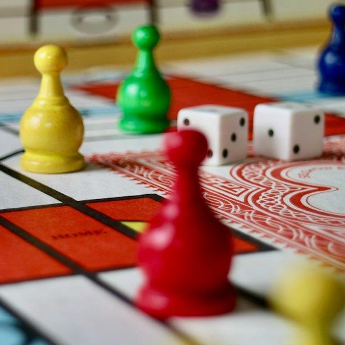 Peões coloridos e dois dados sobre um tabuleiro
